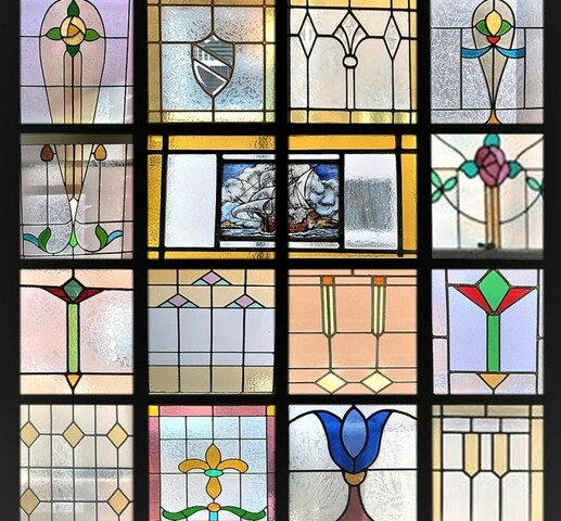 A four by four grid color image of several stained glass window patterns including flowers, a shield and a vivid image of a ship at sea.