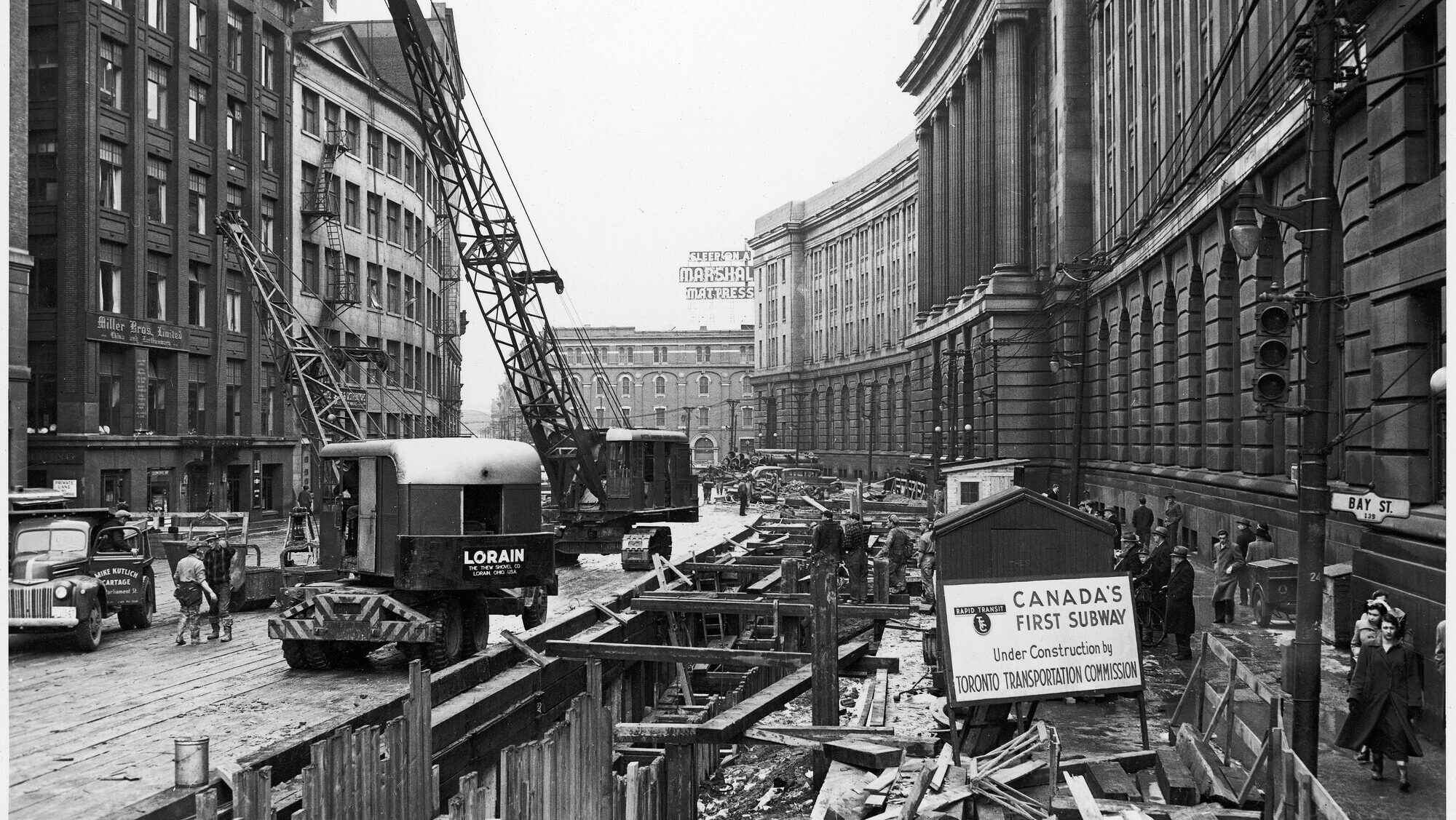image of a construction site and crane with a sign that reads: "Canada's First Subway under construction by Toronto Transportation Commission"