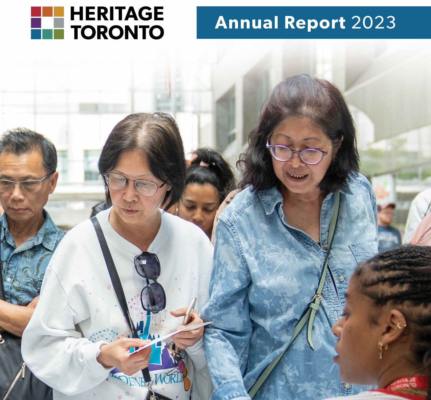Graphic showing an image of a group of people with logo of Heritage Toronto and text reading Annual Report 2023