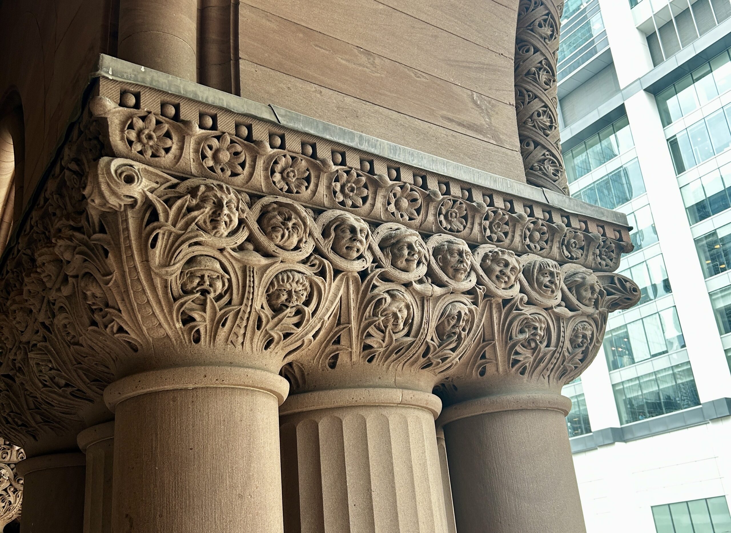 A selection of grotesques carved to resemble human faces atop columns.