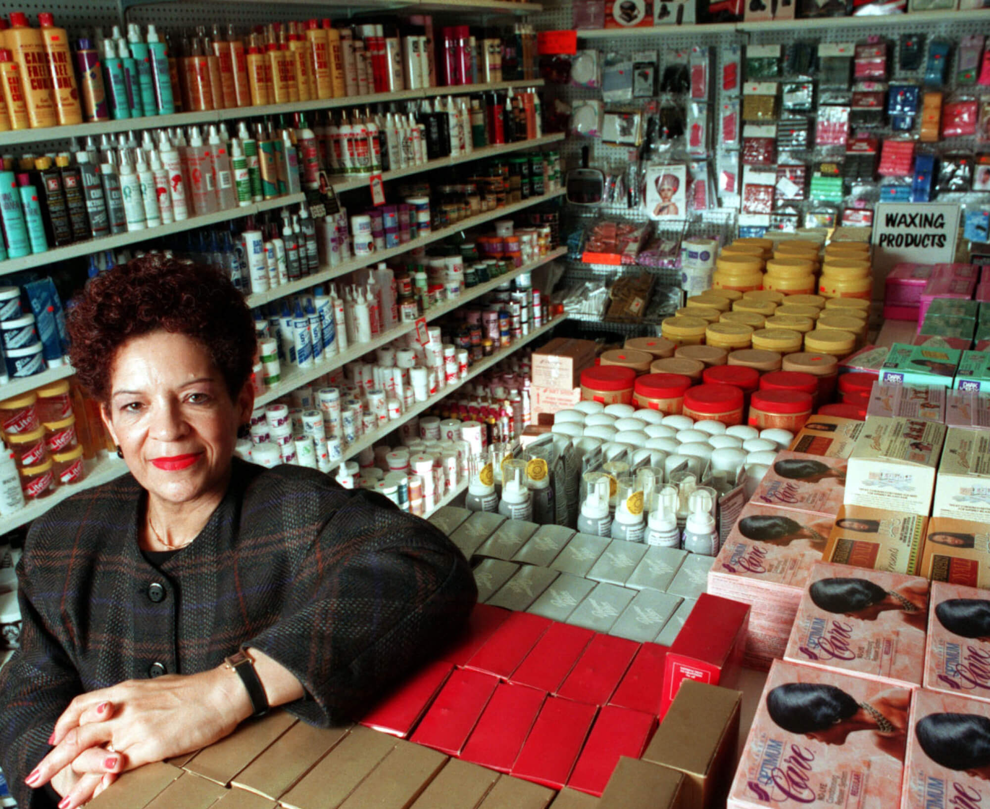 A woman stands in a store crowded with beauty products