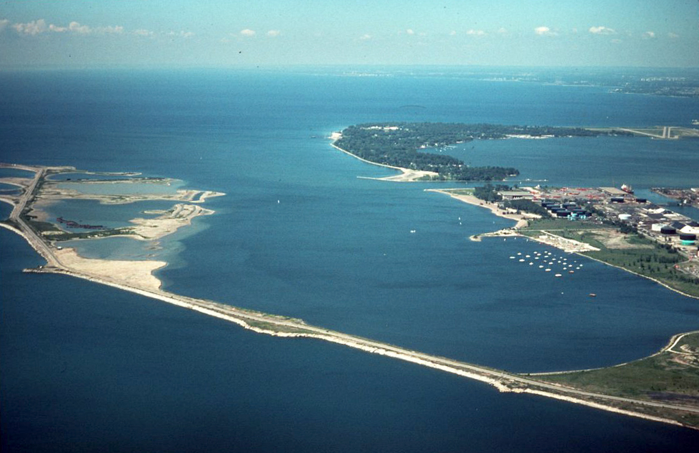 An aerial view of the Leslie Spit, a long and narrow peninsula that goes into a big body of water.