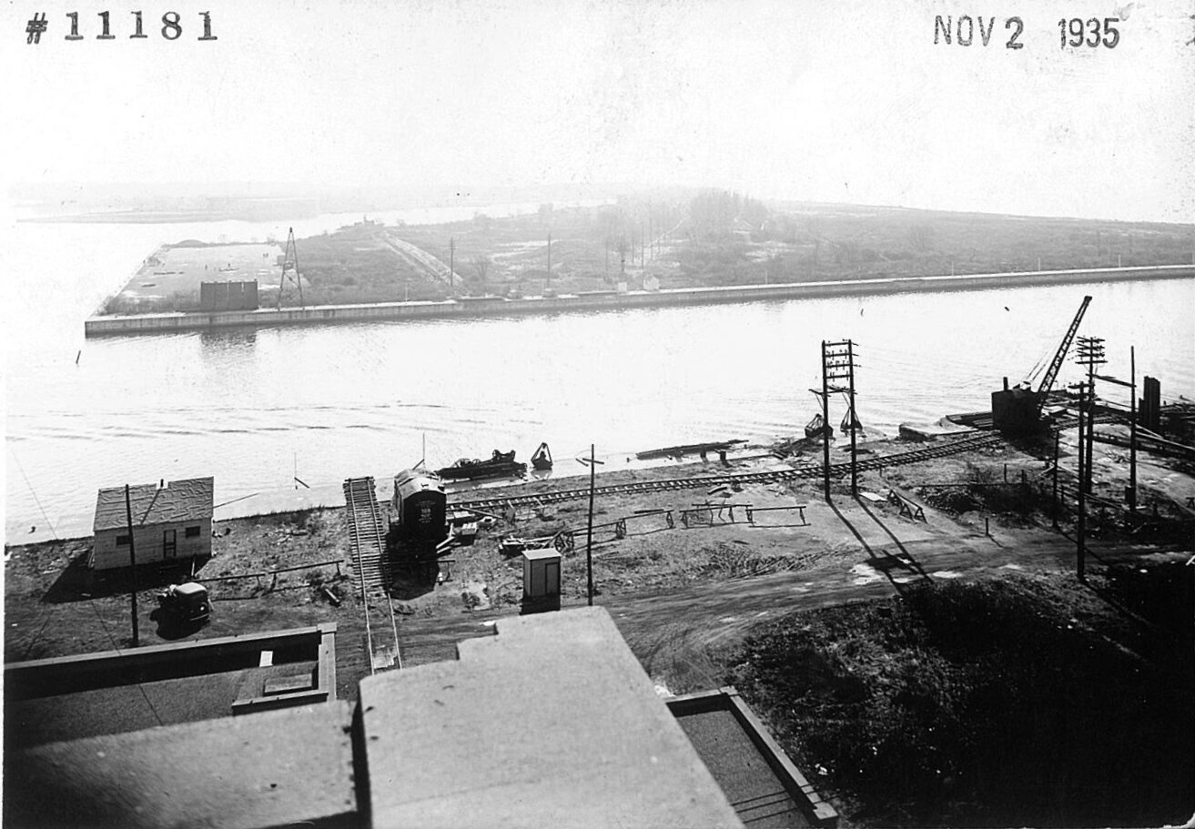 Black and white photograph of constructing taking place at the north side of the Western Channel