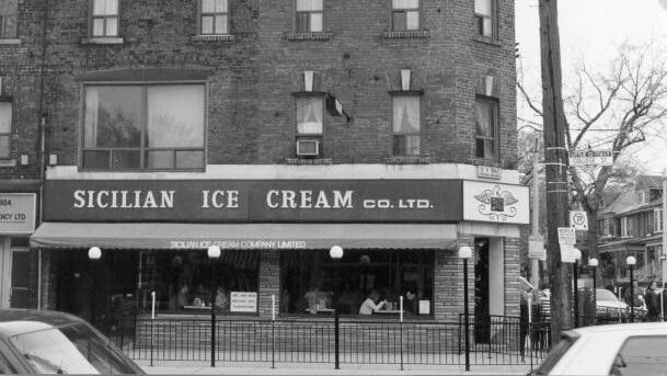 Storefront of Sicilian Ice Cream Co. Ltd. Several people can be seen throught window.