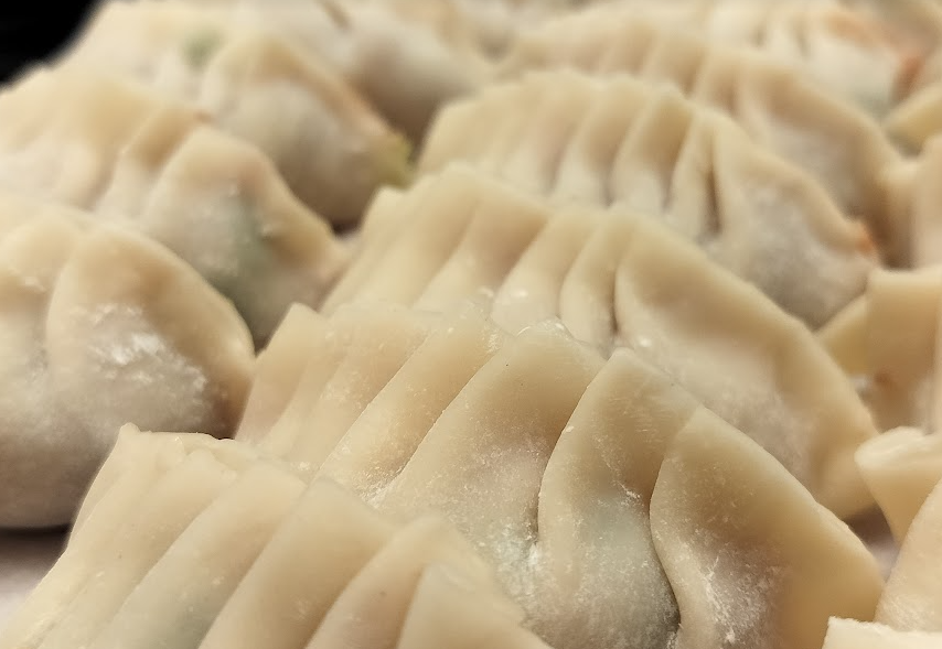 The image is a close-up shot of wrapped dumplings.